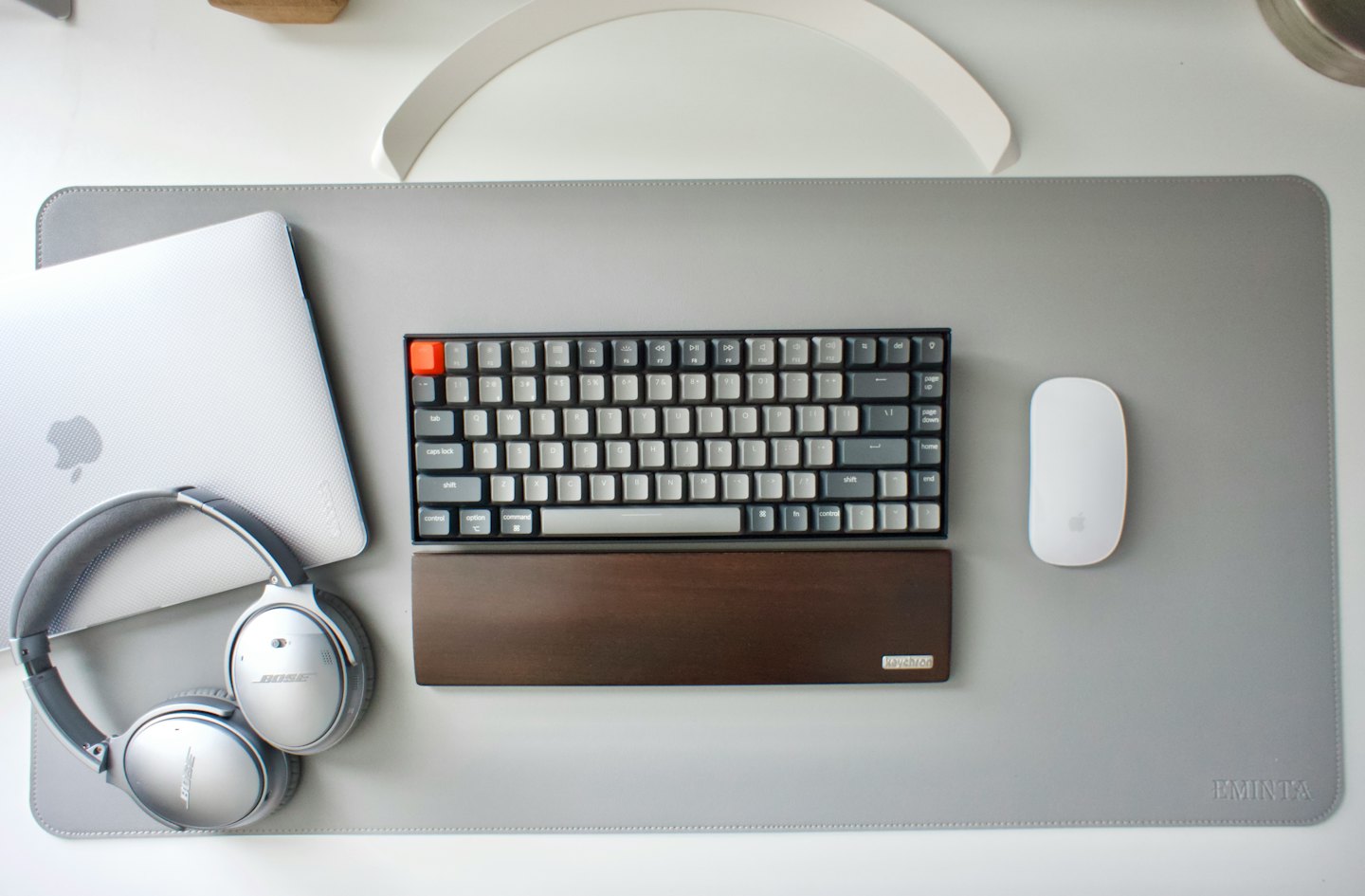 Laptop, cuffie, tastiera e mouse su una scrivania.